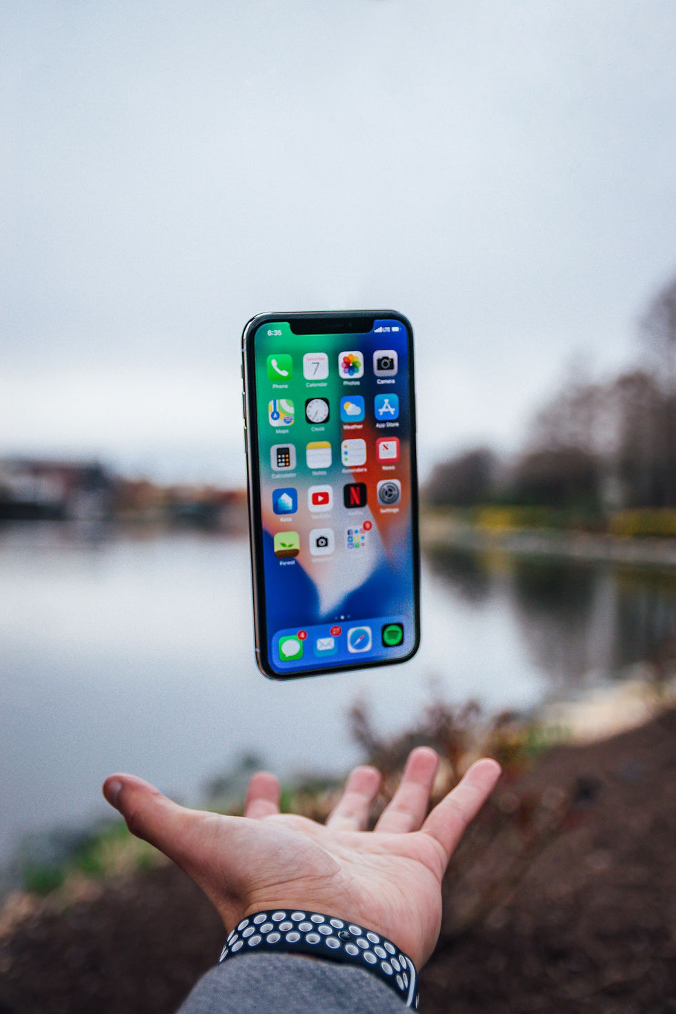iPhone suspended above open hand